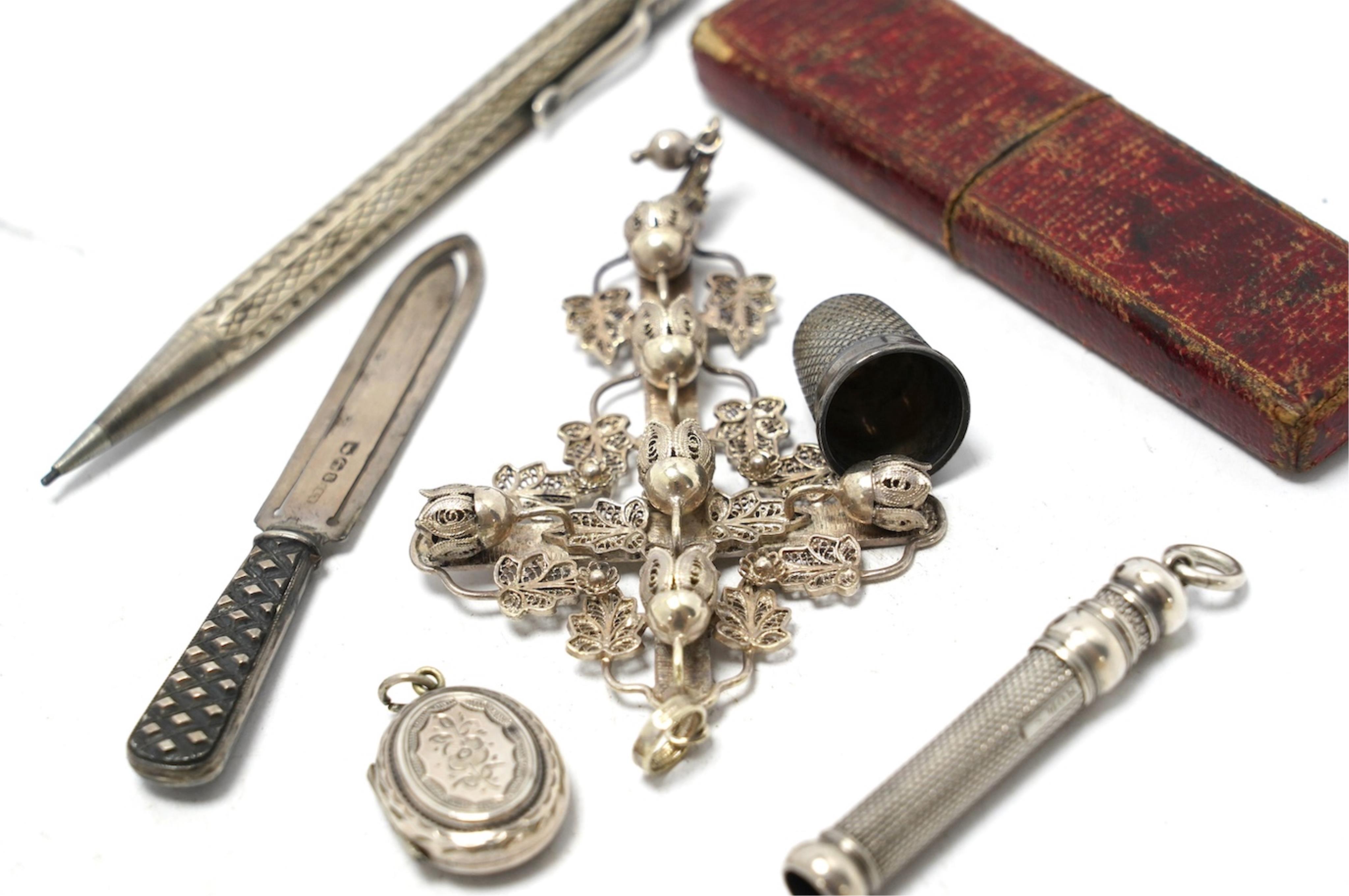 Small silver including a Victorian silver and mother of pearl fruit knife, a crucifix, a book mark, pencils, a thimble, etc. Condition - fair